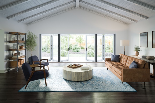 A living room with newly replaced doors leading to a manicured back yard